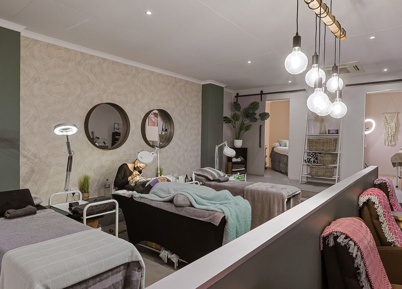 Modern spa interior at Face by Design, Fourways, Gauteng, ZA, showcasing relaxing treatment beds and soft lighting.