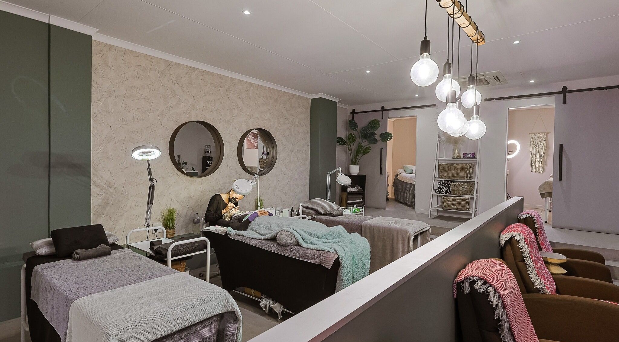 Modern spa interior at Face by Design, Fourways, Gauteng, ZA, showcasing relaxing treatment beds and soft lighting.