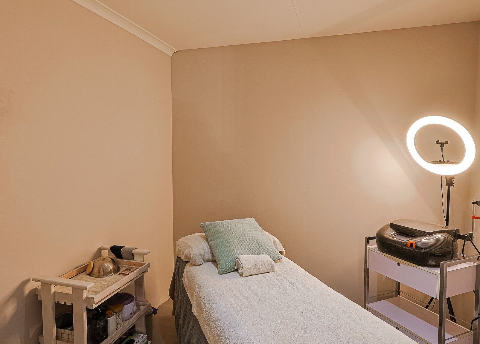 Cozy treatment room at Face by Design, Fourways, Gauteng, ZA featuring a plush bed and relaxing lighting.