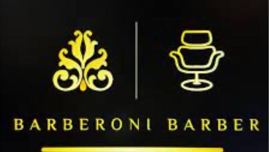 Gold logo of Barberoni Barber in Il-Mellieħa, MT with ornate design and barber chair icon.