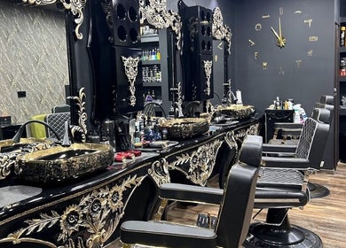 Luxurious interior of Barberoni Barber in Il-Mellieħa, MT featuring ornate mirrors and barber chairs.