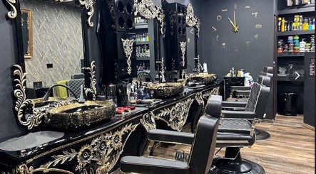 Luxurious interior of Barberoni Barber in Il-Mellieħa, MT featuring ornate mirrors and barber chairs.