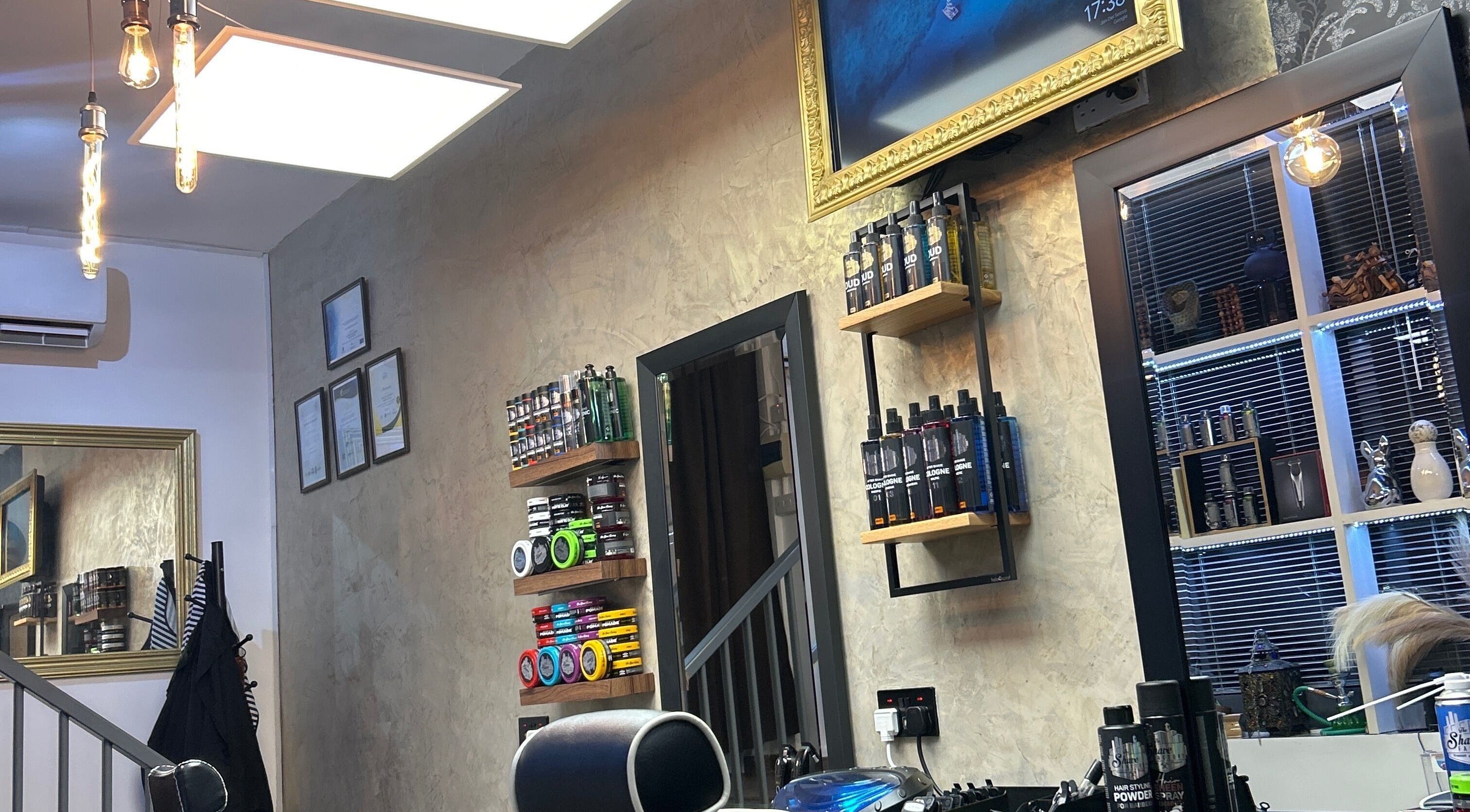 Modern interior of Barberoni Barber² in Iż-żurrieq, MT, featuring sleek shelves with grooming products.