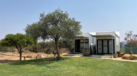 Exterior view of Precious Pearl Health and Skin Care in Windhoek, Khomas Region, NA surrounded by lush greenery.