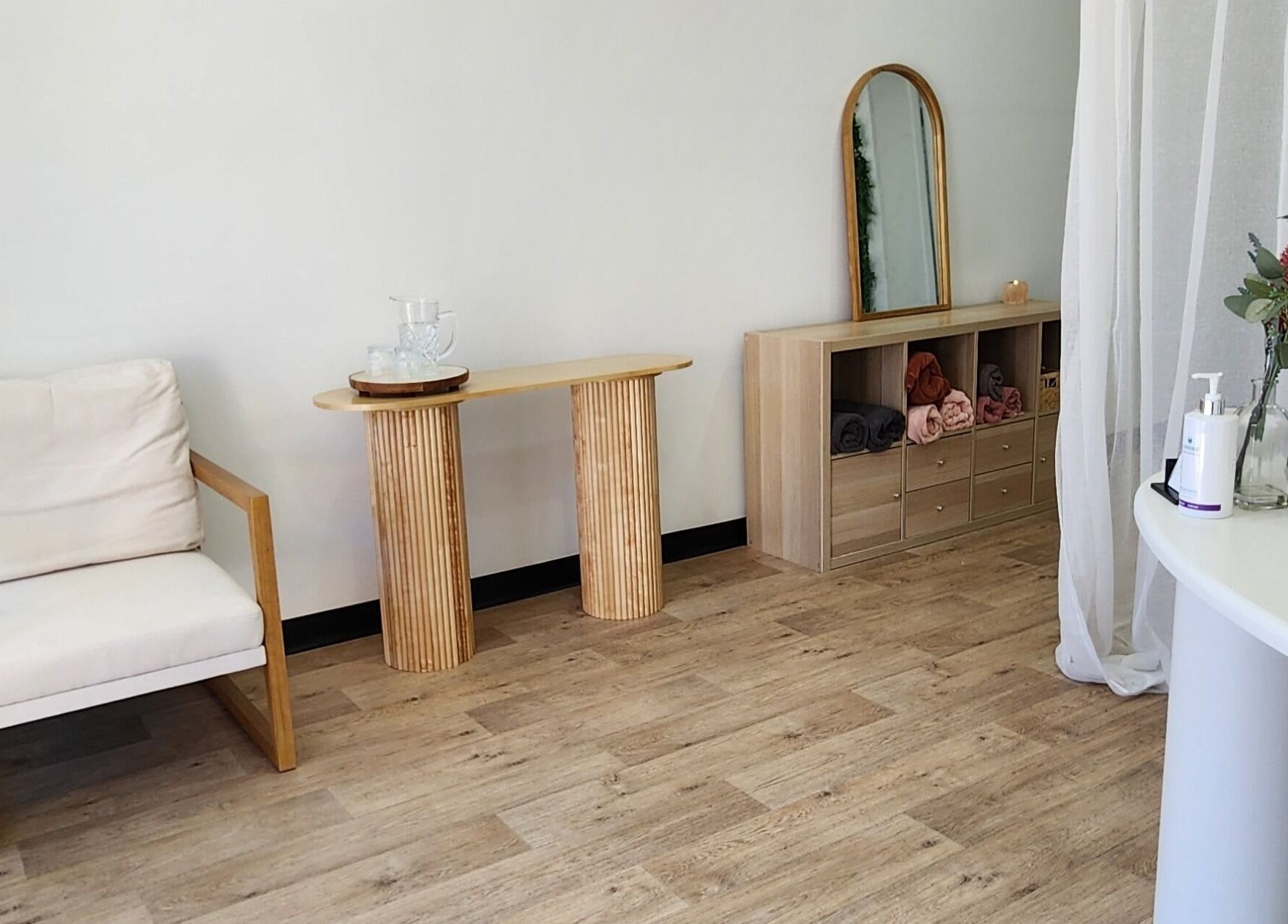 Chic interior of Dluxe Beauty and Brows in Waratah, New South Wales, featuring a cozy chair and modern decor.