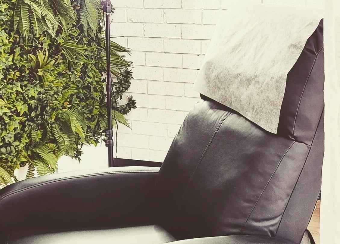 Relaxing treatment chair at Dluxe Beauty and Brows, Waratah, New South Wales, AU, with lush green decor.