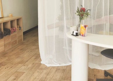 Dluxe Beauty and Brows reception area in Waratah, New South Wales, AU with elegant decor and wooden flooring.
