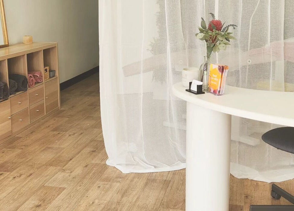 Dluxe Beauty and Brows reception area in Waratah, New South Wales, AU with elegant decor and wooden flooring.