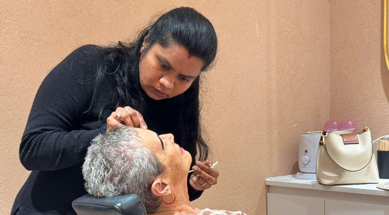 Stylist shaping eyebrows at Beauty Hub - Carindale, Carindale, Queensland, AU.