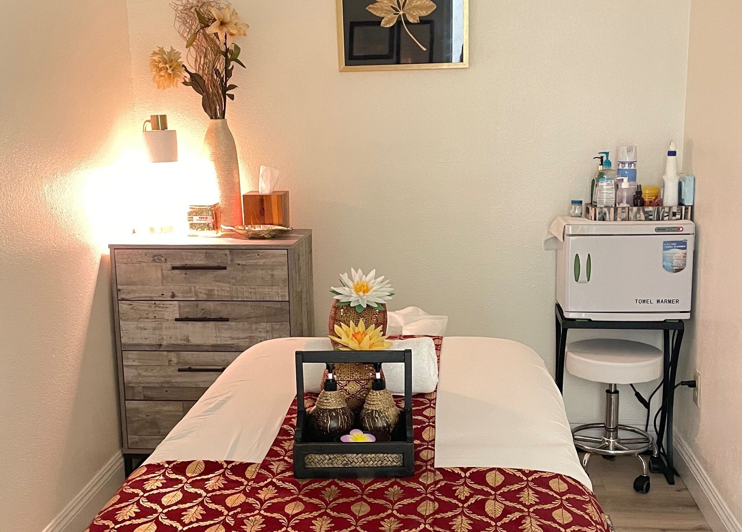 Tranquil massage room at Kinnaree Thai Spa in Fresno, California, US, featuring soft lighting and elegant decor.