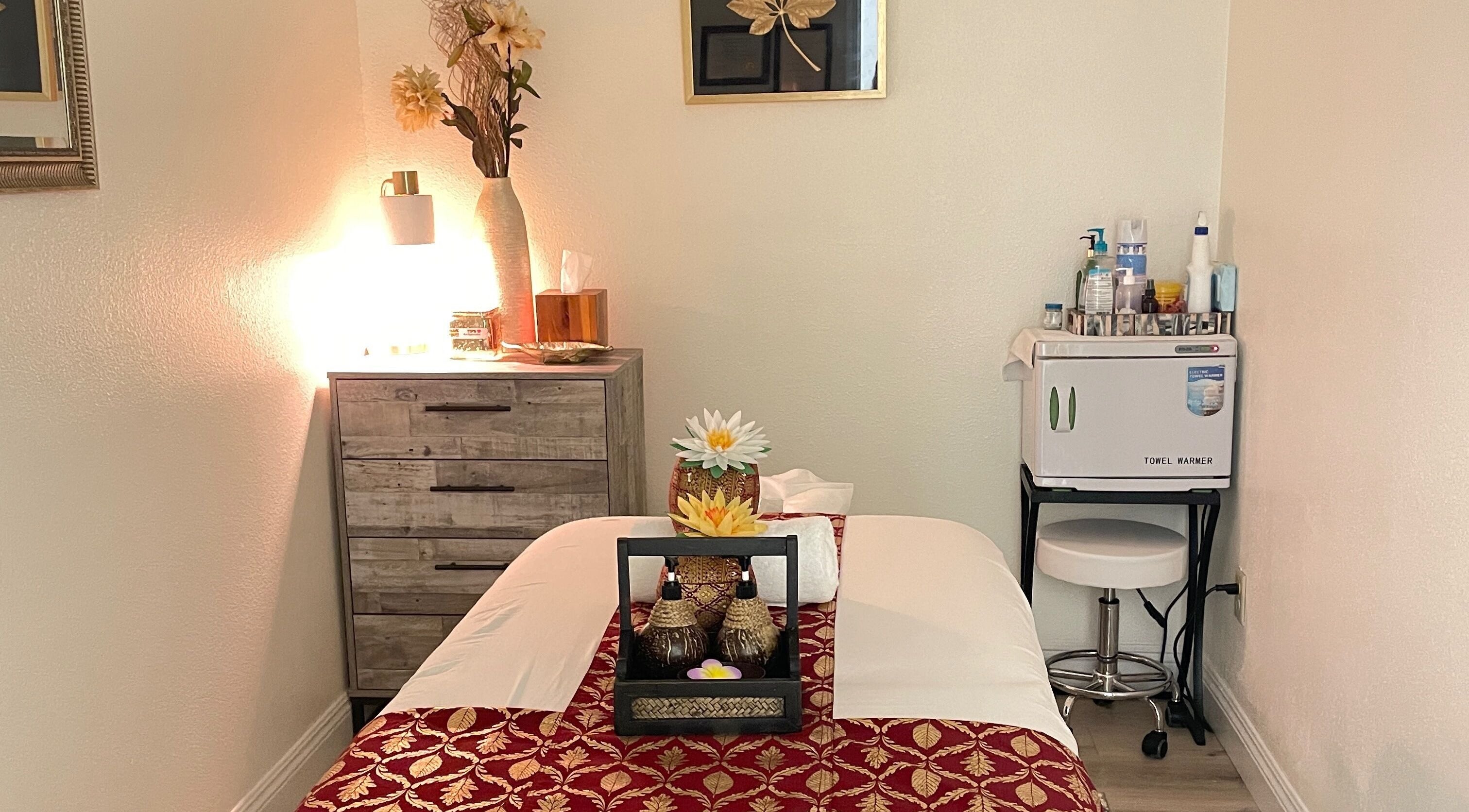 Tranquil massage room at Kinnaree Thai Spa in Fresno, California, US, featuring soft lighting and elegant decor.