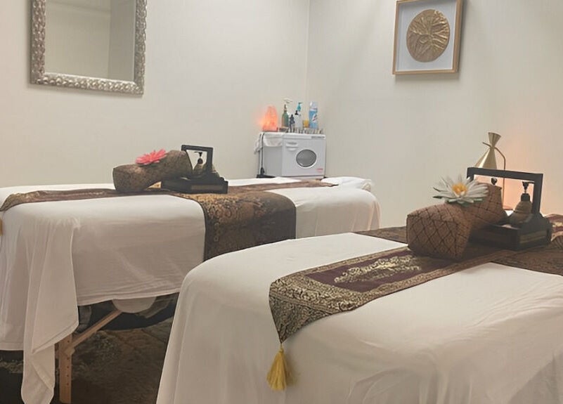 Tranquil massage room at Kinnaree Thai Spa, Fresno, California, US, featuring elegant decor and twin treatment tables.