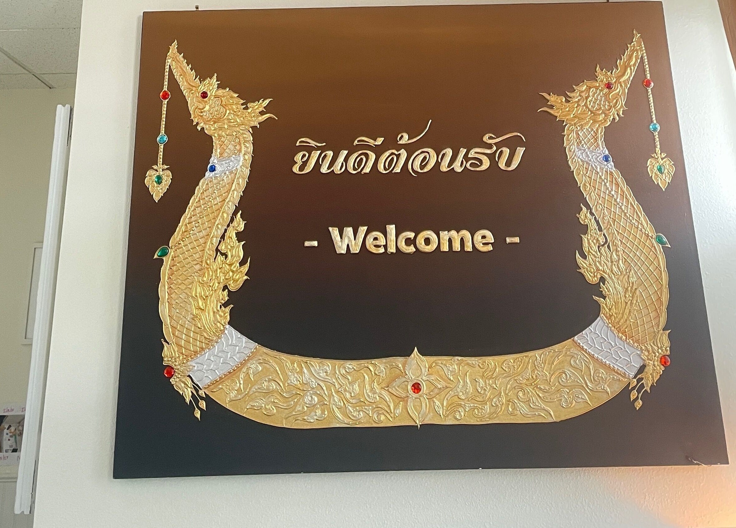Decorative welcome sign at Kinnaree Thai Spa in Fresno, California, US featuring golden ornate designs.