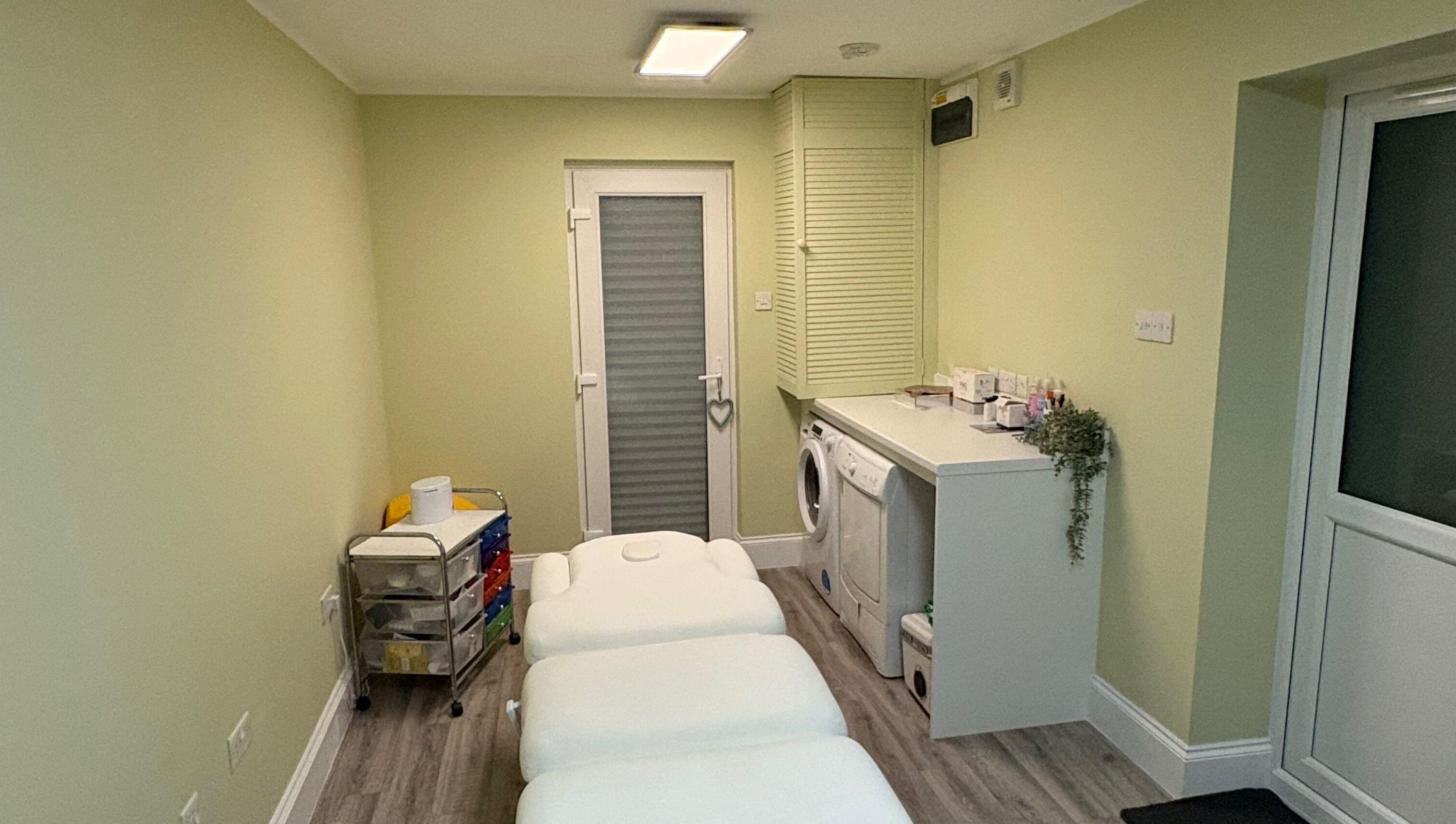 A tranquil treatment room at Radiant by Julie in Derby, England, GB, featuring cozy massage tables.