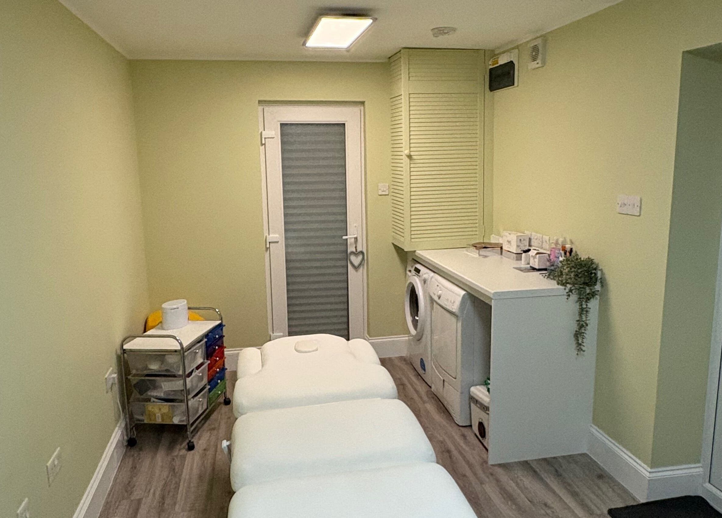 A tranquil treatment room at Radiant by Julie in Derby, England, GB, featuring cozy massage tables.