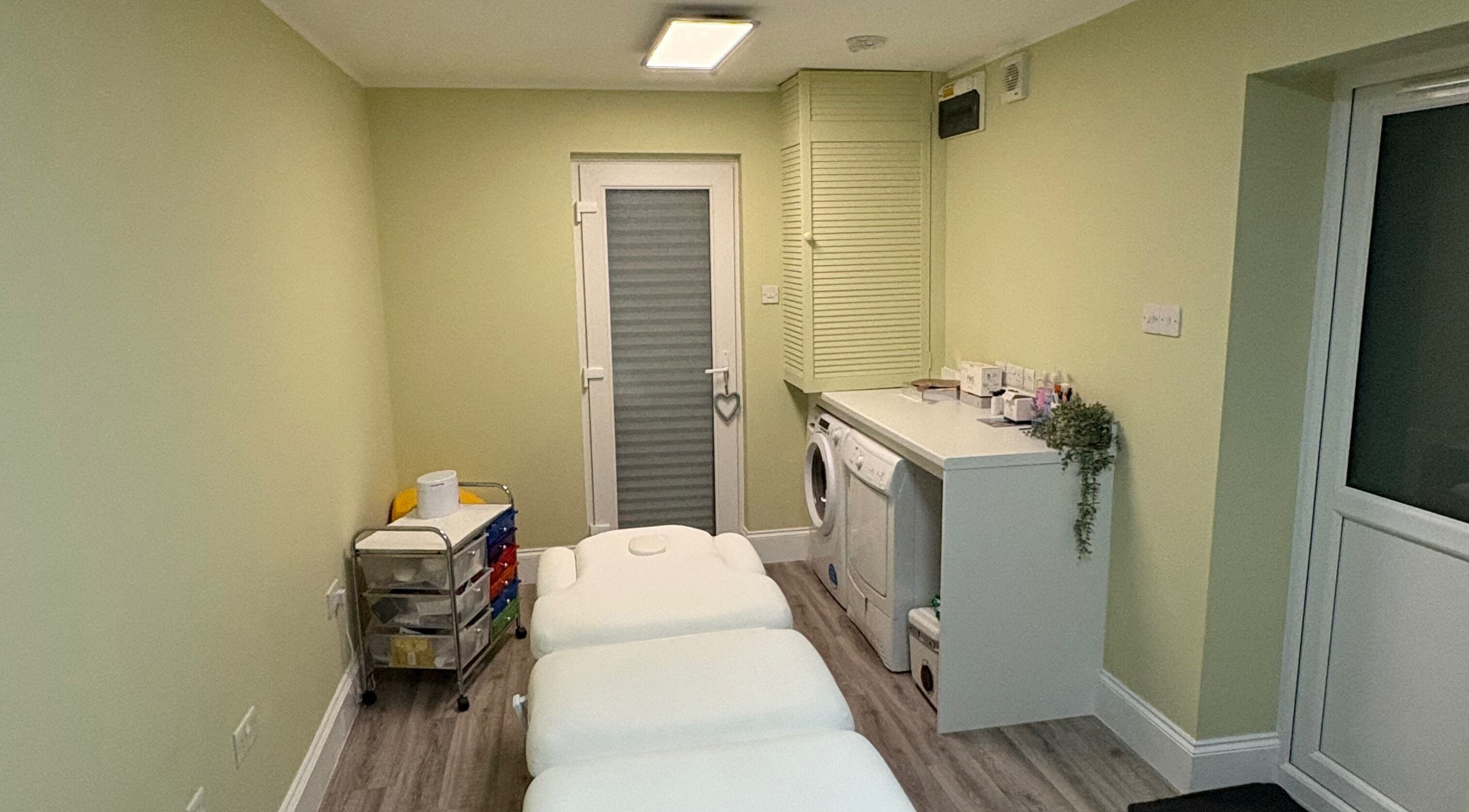 A tranquil treatment room at Radiant by Julie in Derby, England, GB, featuring cozy massage tables.