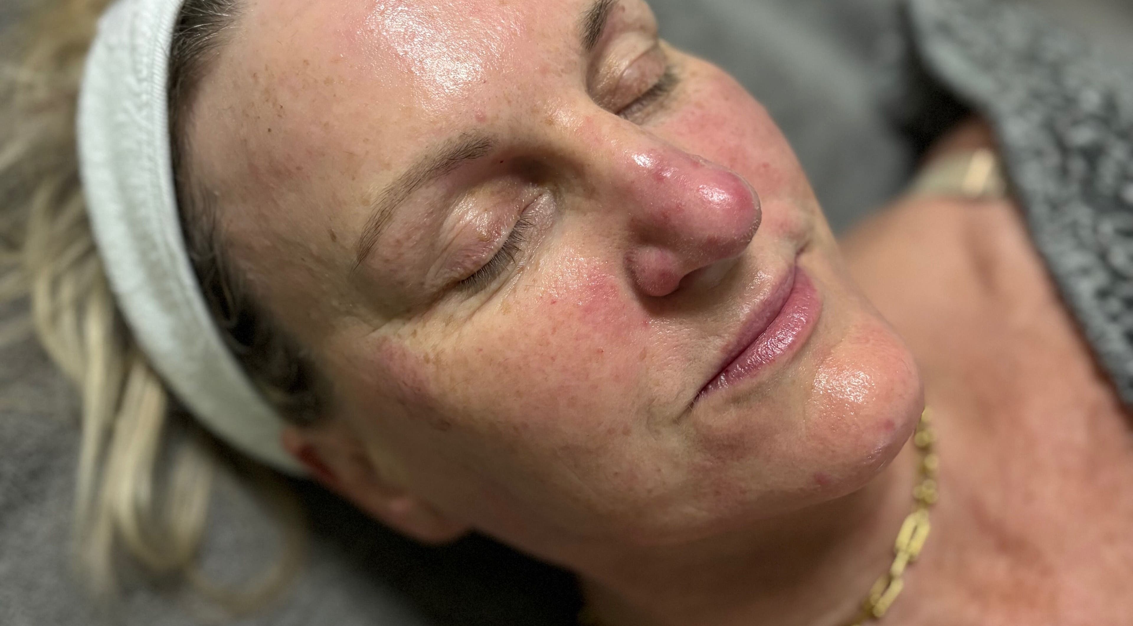 Relaxed woman post-facial at Radiant by Julie, Derby, England, GB, highlighting glowing skin.