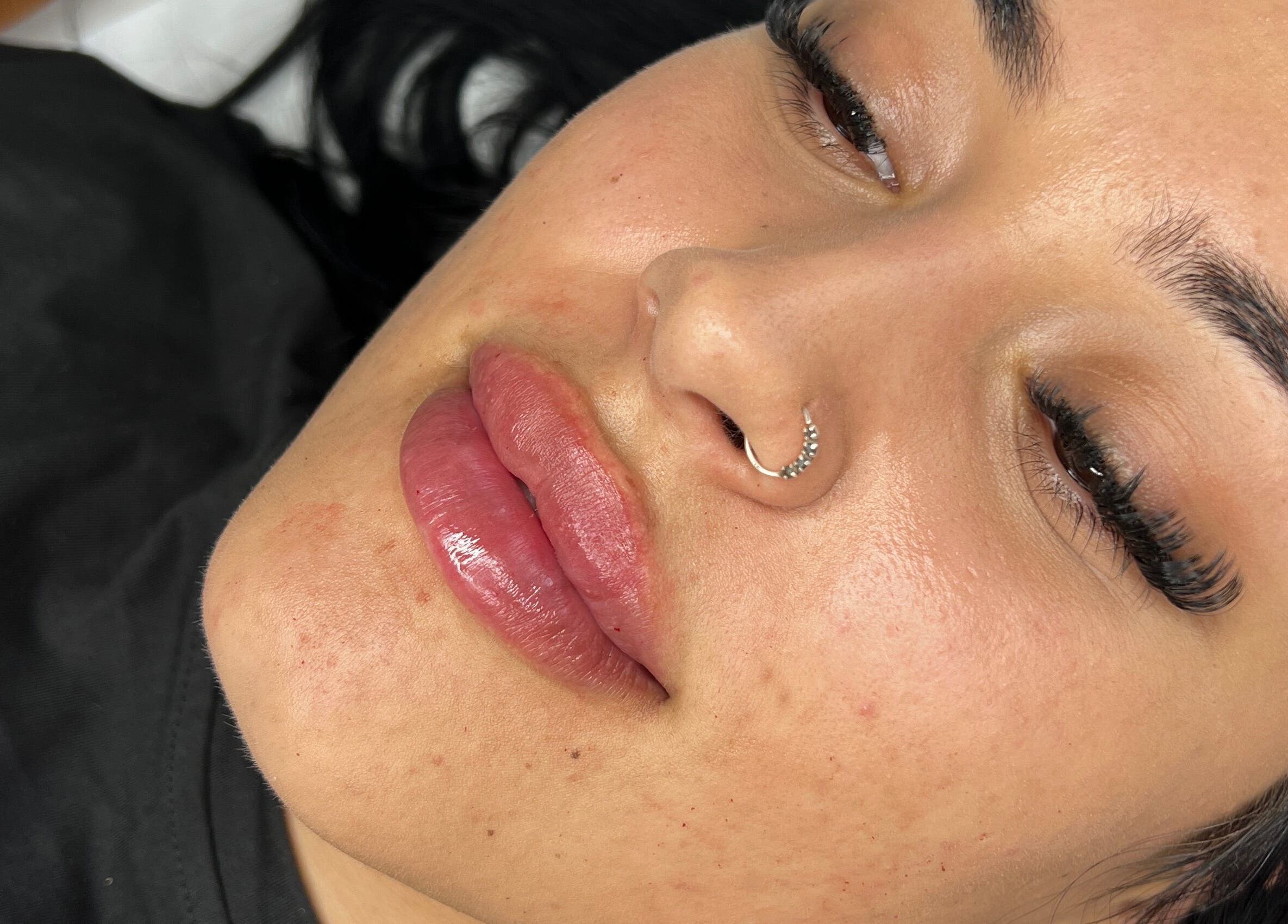 Close-up of woman's face with enhanced lips at Radiant by Julie, Derby, England, GB.