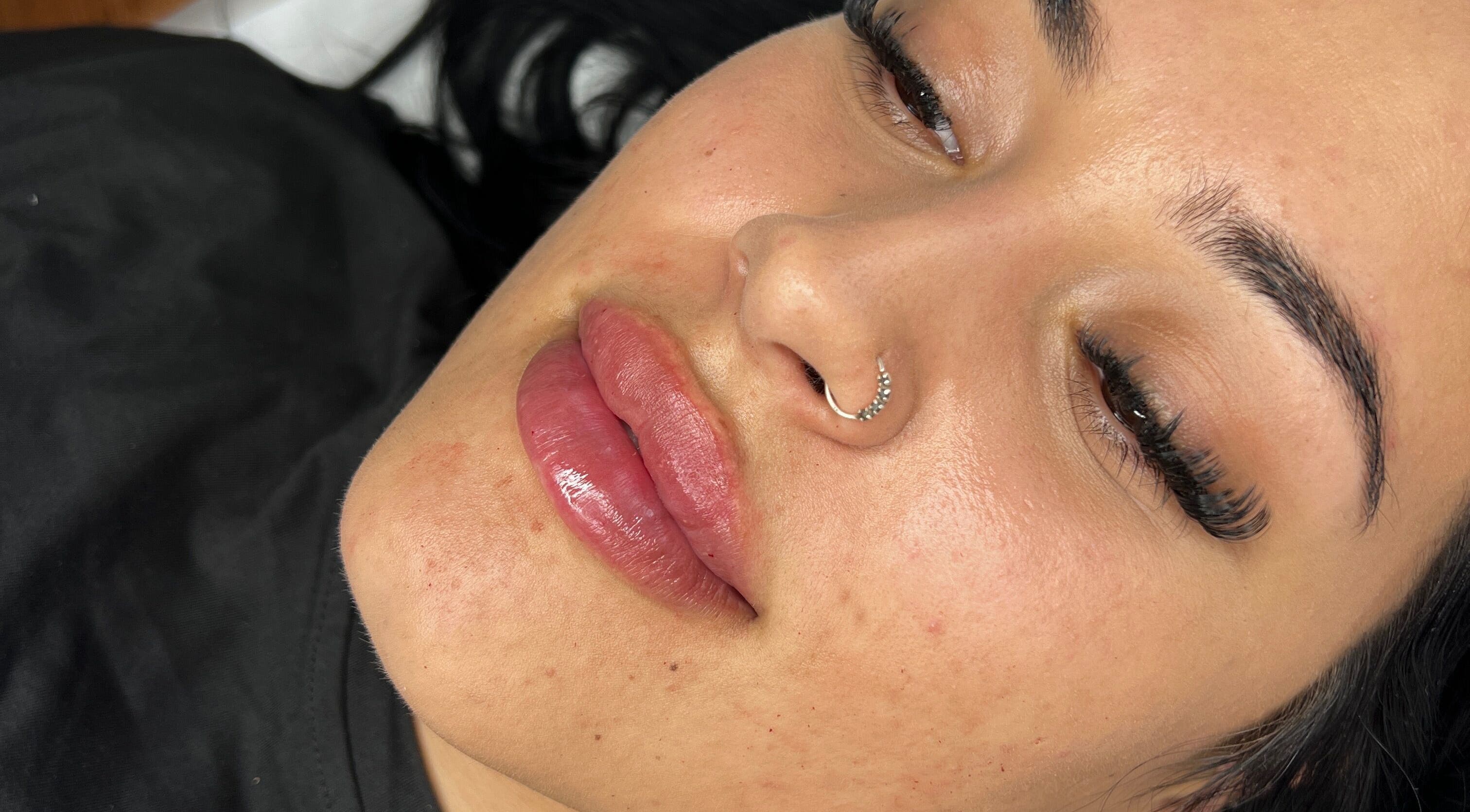 Close-up of woman's face with enhanced lips at Radiant by Julie, Derby, England, GB.