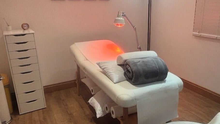 Massage table with warm lighting at The Beauty in you at The Little Health Barn, Leatherhead, England, GB.