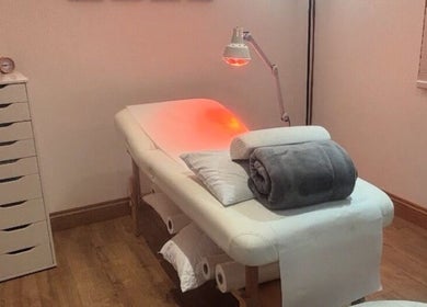Massage table with warm lighting at The Beauty in you at The Little Health Barn, Leatherhead, England, GB.
