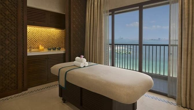 Serene spa room at Jouri Rose Spa, Ras al Khaimah, AE with ocean view and massage table.