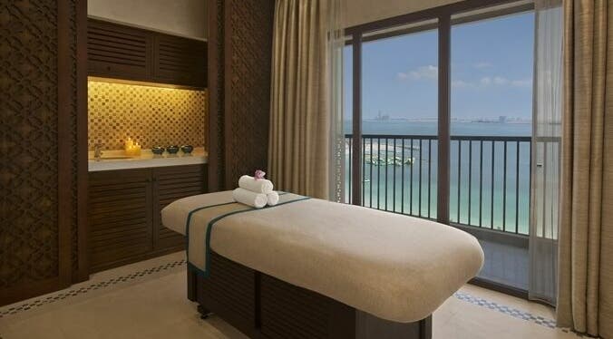 Serene spa room at Jouri Rose Spa, Ras al Khaimah, AE with ocean view and massage table.