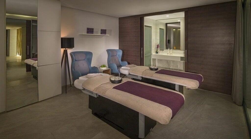 Luxurious spa room at Jouri Rose Spa in Ras al Khaimah, AE, featuring two massage tables for ultimate relaxation.