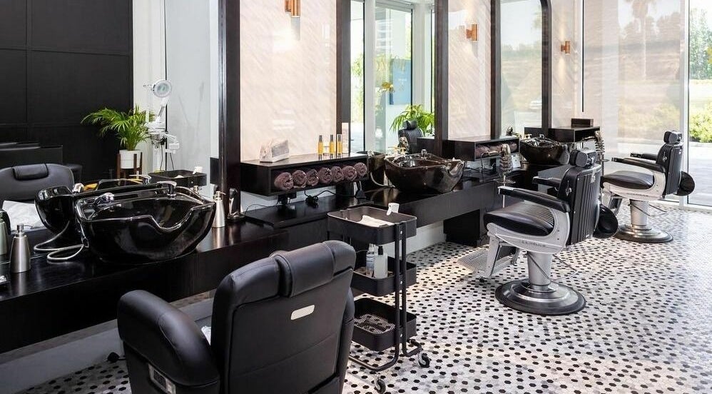 Stylish interior of Razor Barber Shop in Dubai, AE with modern chairs and sleek design.