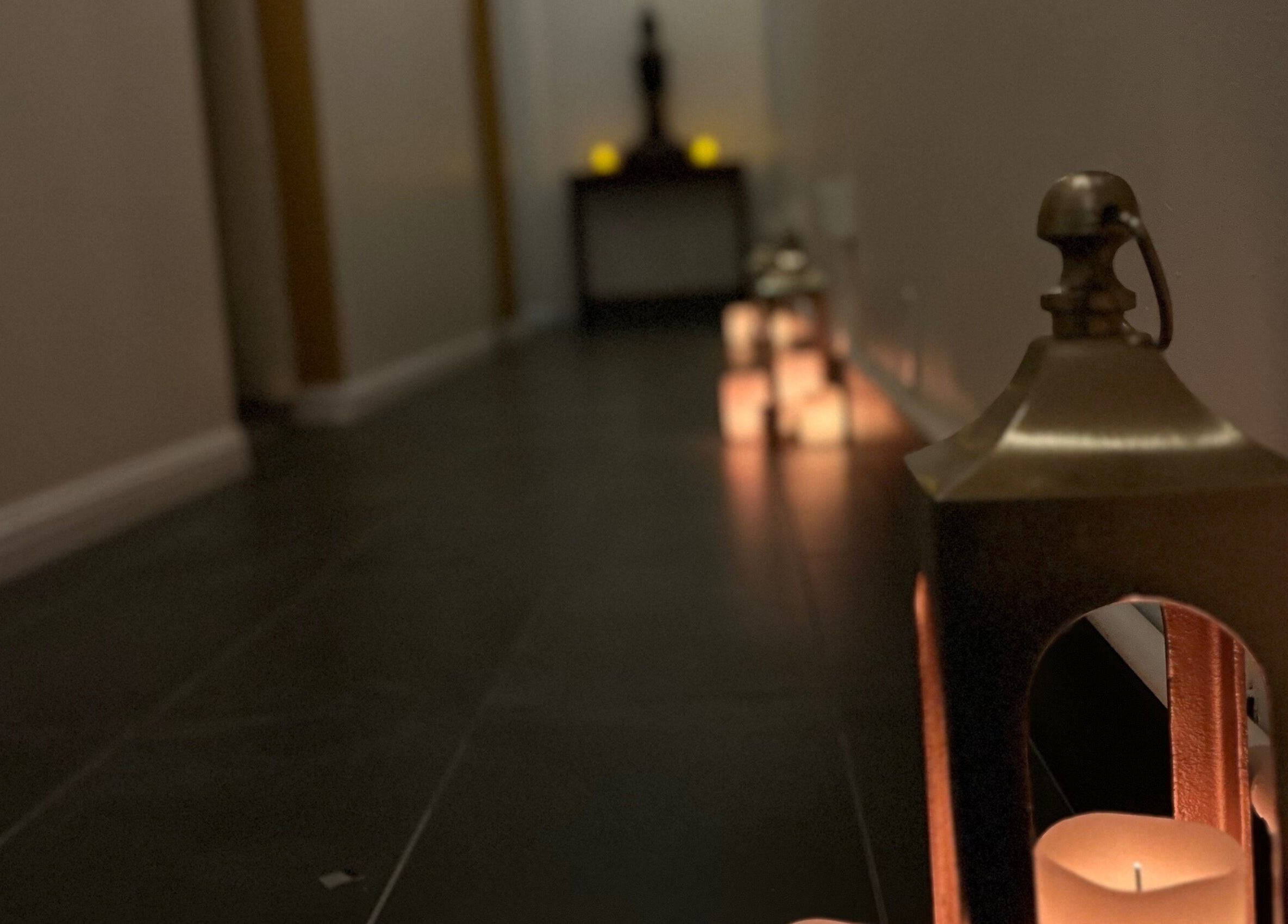 Dimly lit hallway with candles at SIAM WALA Therapeutic Massage, El Segundo, California, US.