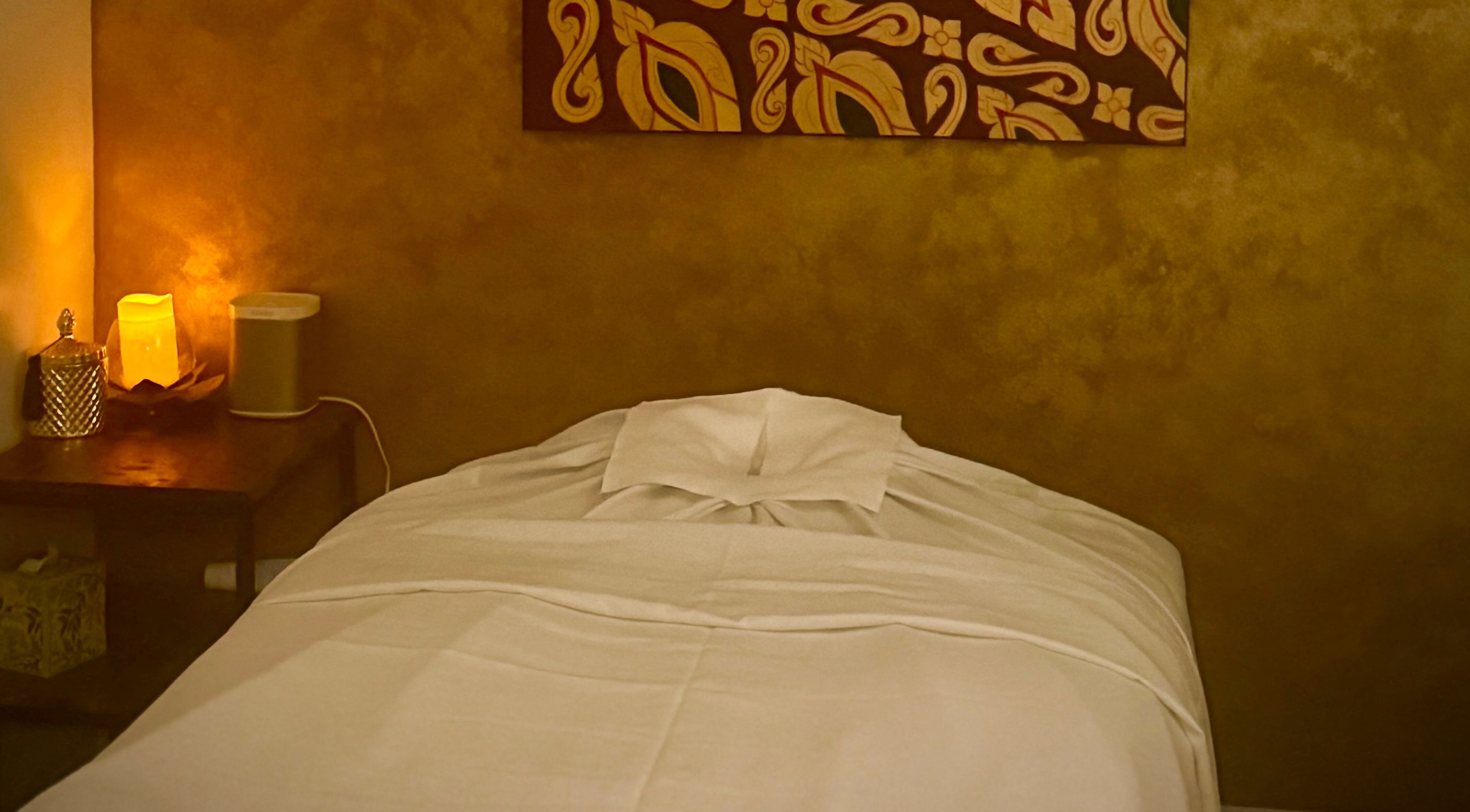 Cozy massage room at SIAM WALA Serenity Spa in Torrance, California, US, with warm lighting and elegant decor.