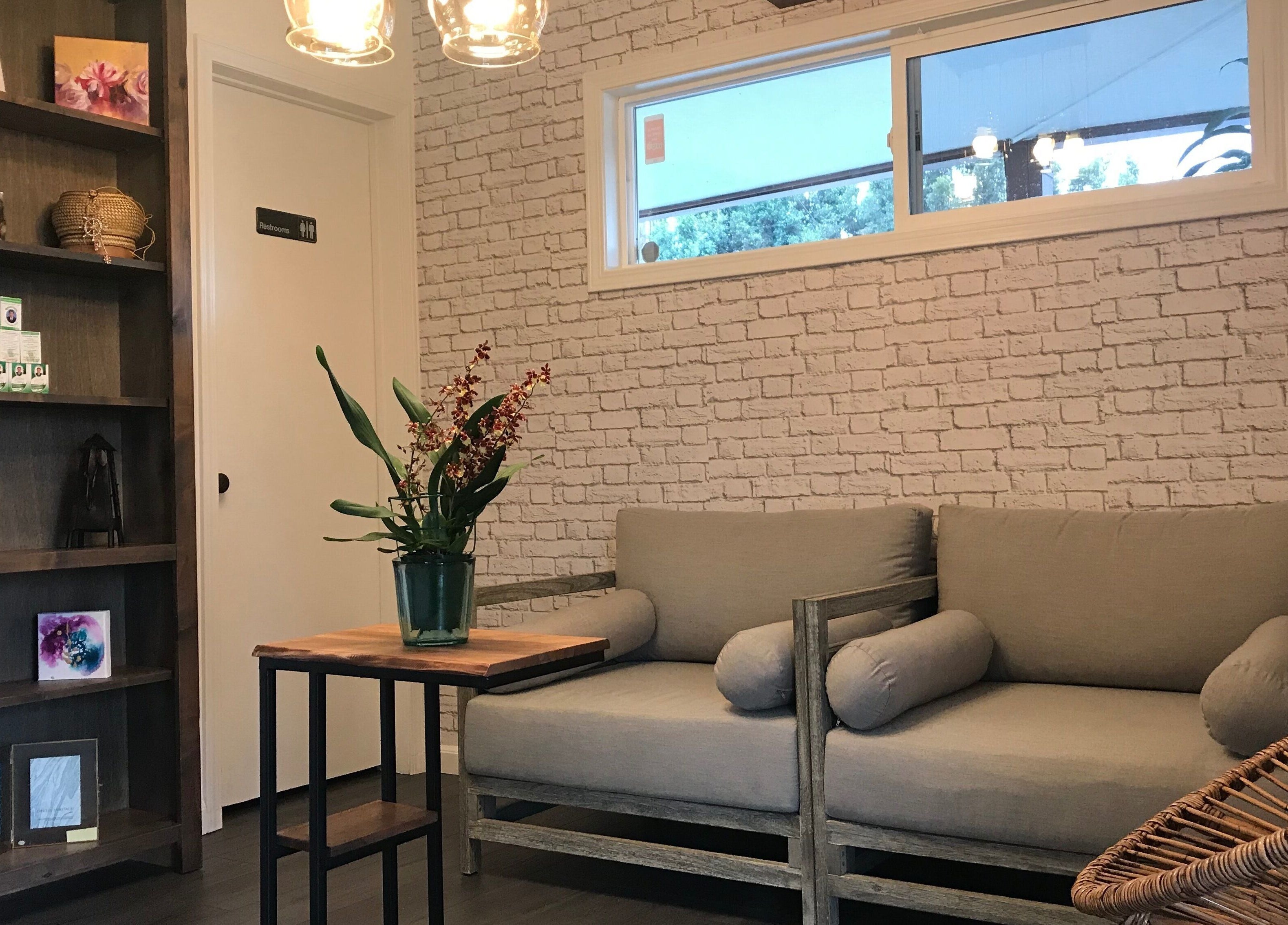 Relaxing seating area at SIAM WALA Serenity Spa in Torrance, California, US, featuring cozy sofas and decor.