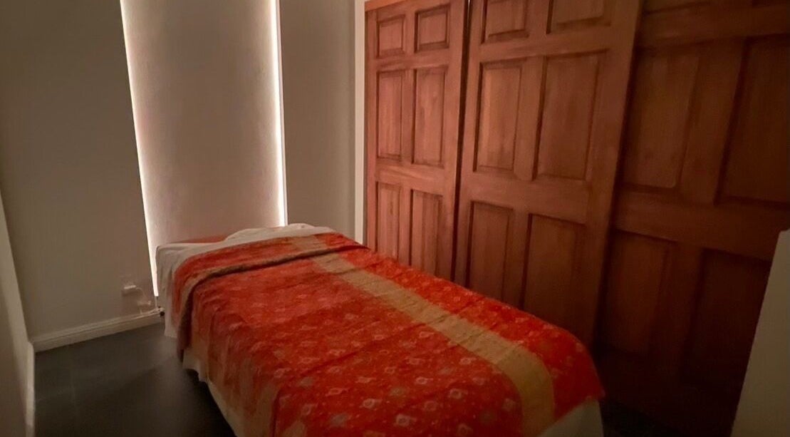 Cozy massage room at SIAM WALA Therapeutic Massage in El Segundo, California, US with warm wooden decor.