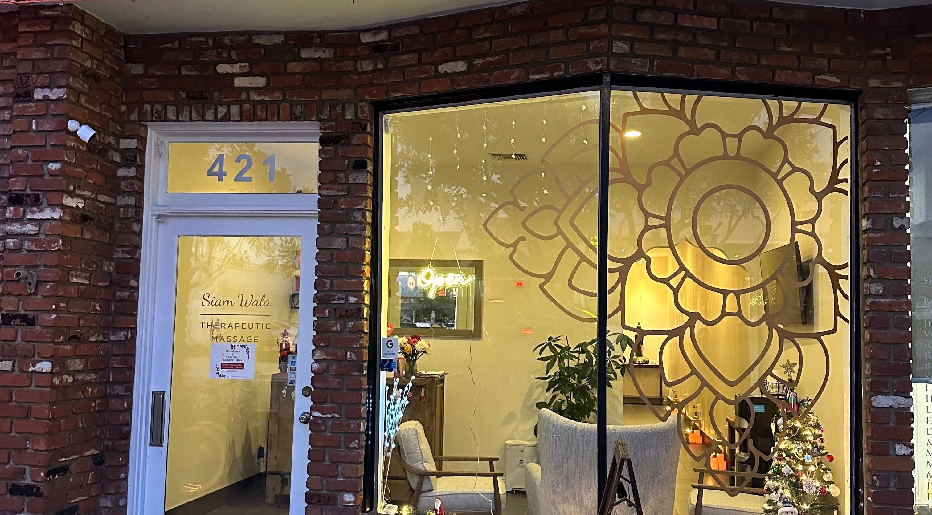 Exterior of SIAM WALA Therapeutic Massage in El Segundo, California, US, featuring elegant window decor.