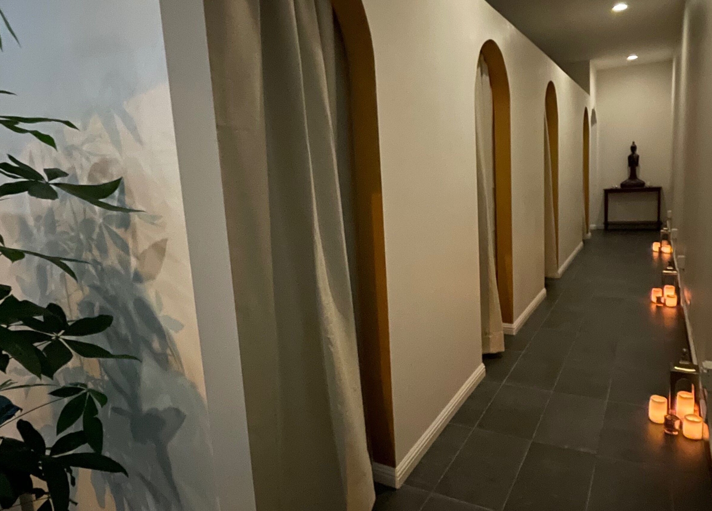 Tranquil hallway at SIAM WALA Therapeutic Massage in El Segundo, California, US with candles and decor.