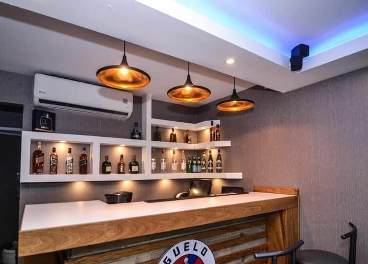 Elegant bar setup at Guelo Barber Studio, Santo Domingo, DO, showcasing a stylish and inviting atmosphere.