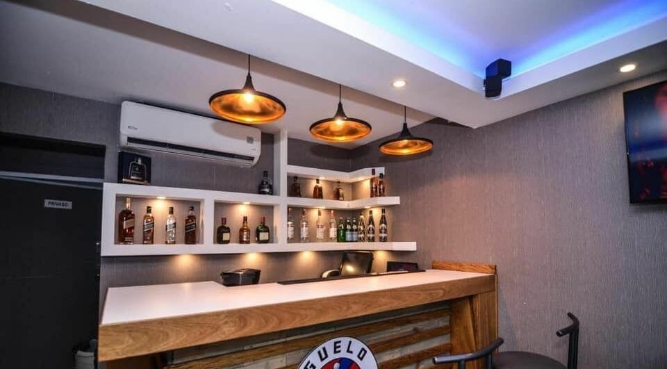 Elegant bar setup at Guelo Barber Studio, Santo Domingo, DO, showcasing a stylish and inviting atmosphere.