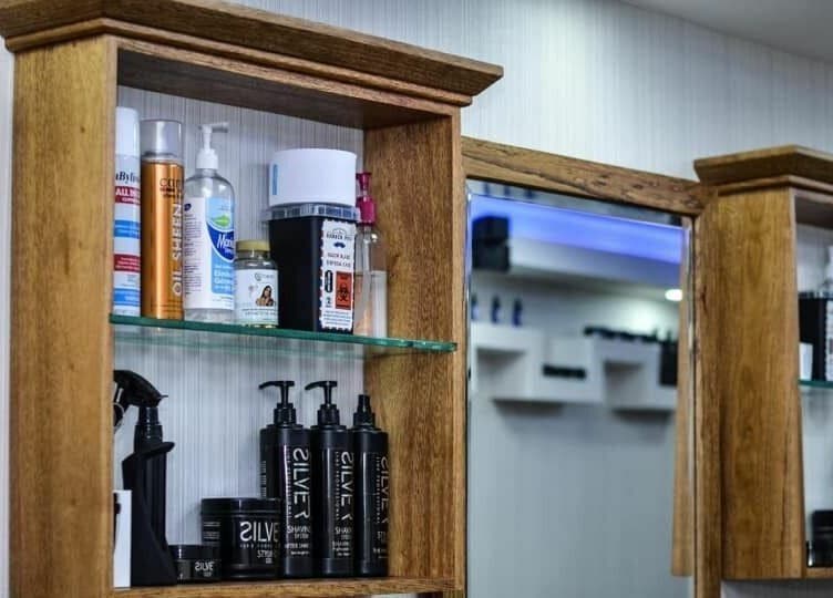 Well-organized shelf with hair products at Guelo Barber Studio, Santo Domingo, DO.