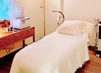 Relaxing treatment room at Lizii Skincare Studio, Las Vegas, Nevada, US. Cozy bed, ambient lighting, and facial equipment.