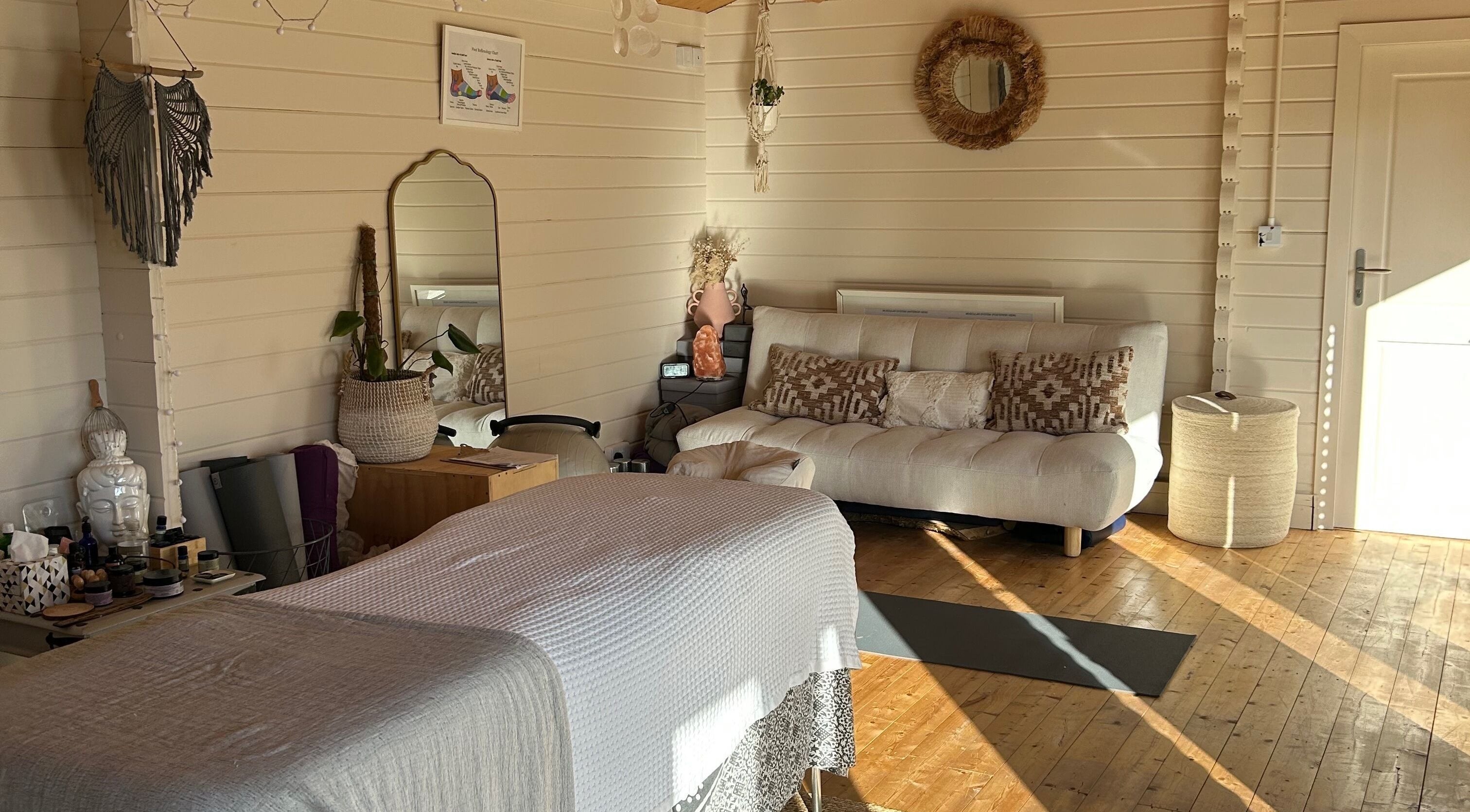 Relaxing therapy room at B-Massaged, Bromsgrove, England, GB with cozy decor and natural light.