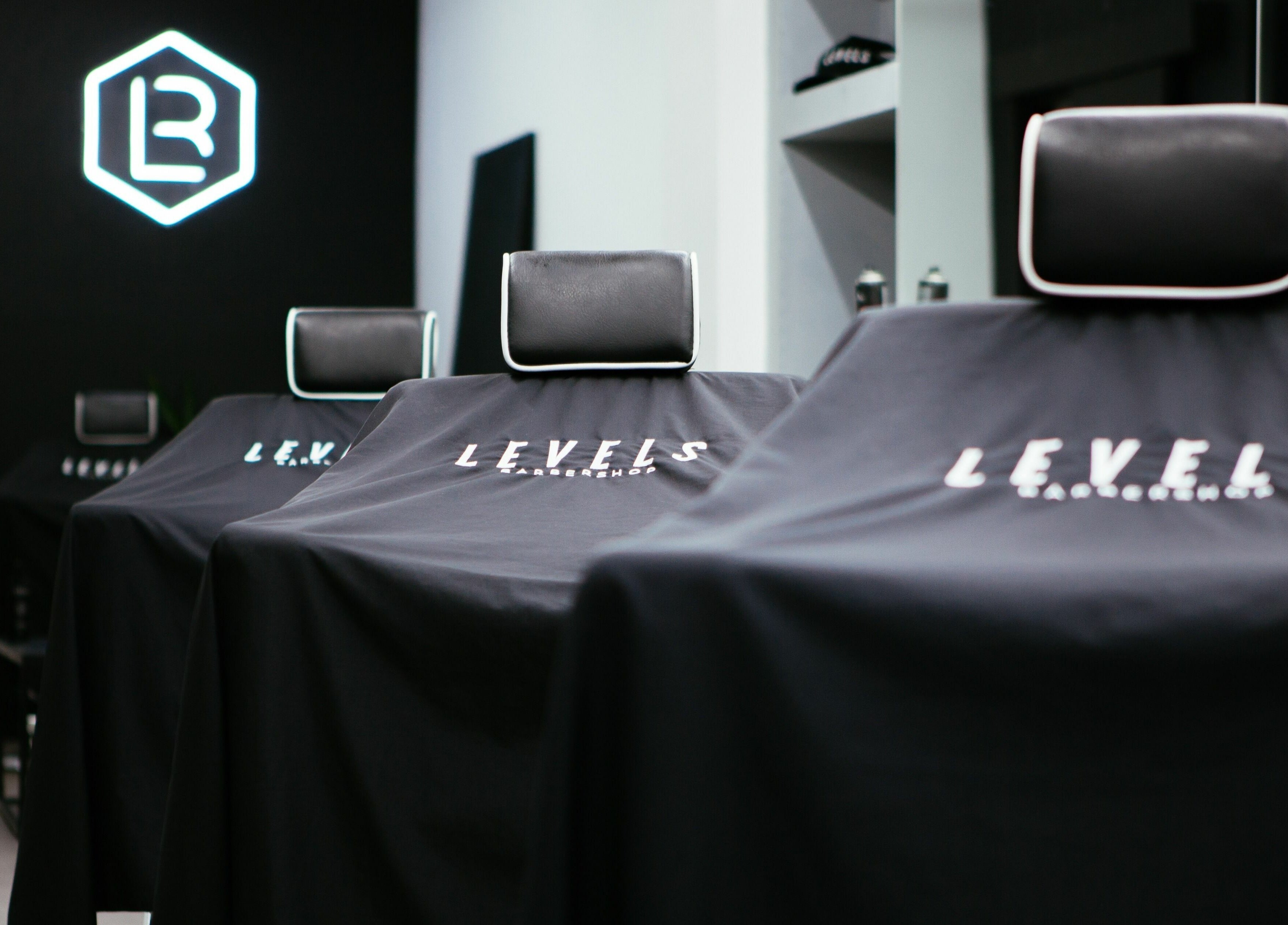 Stylish barber chairs at Levels Mens Grooming in Newton Abbot, England, GB. Sleek black design enhances modern feel.