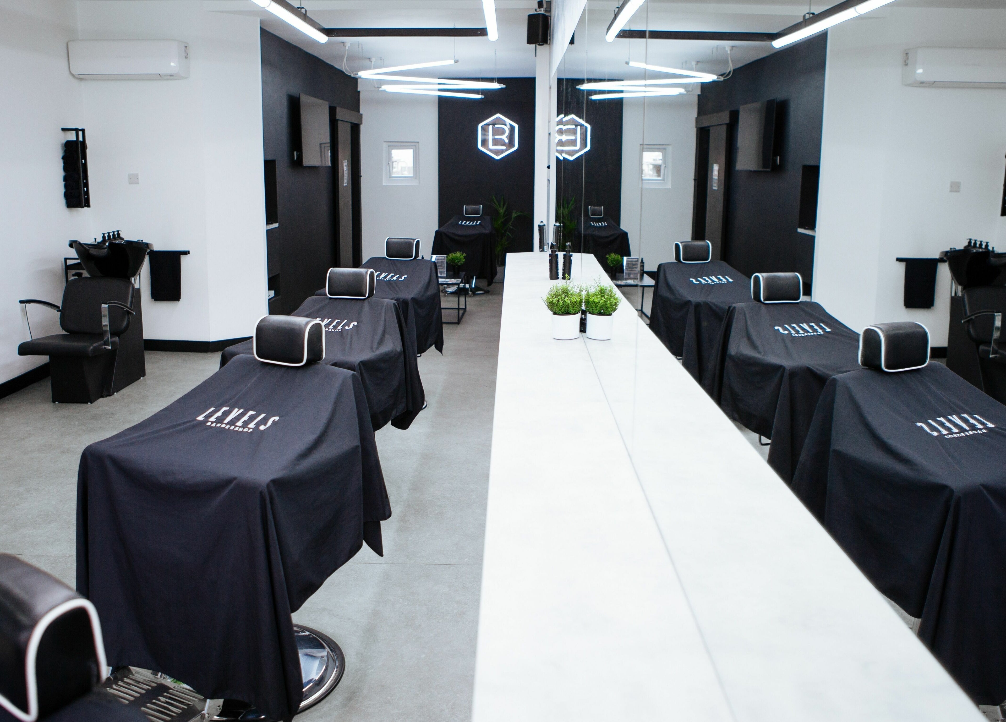 Chic interior of Levels Mens Grooming in Newton Abbot, England, showcasing barber chairs and modern decor.