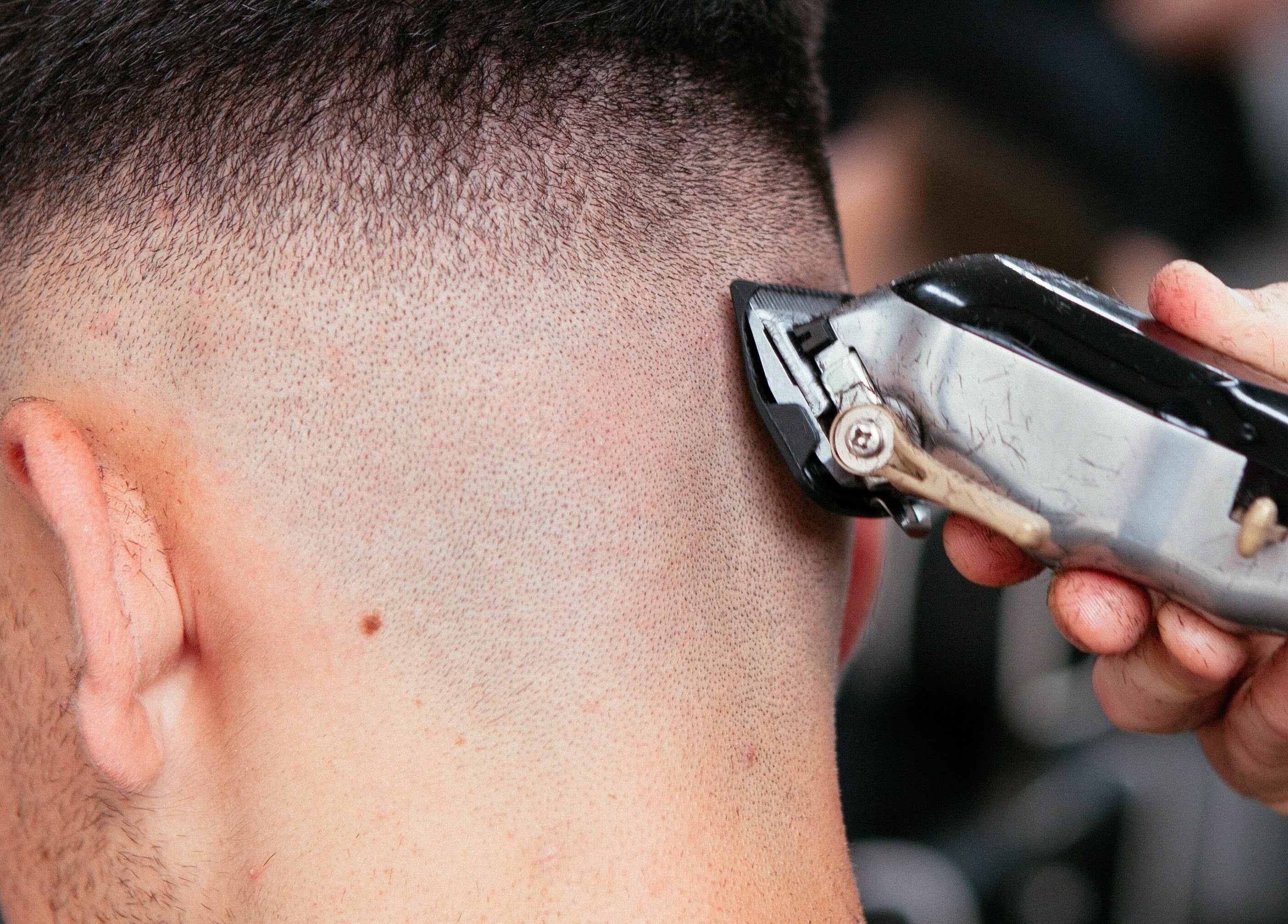 Close-up of precise clipper haircut at Levels Mens Grooming, Newton Abbot, England, GB.