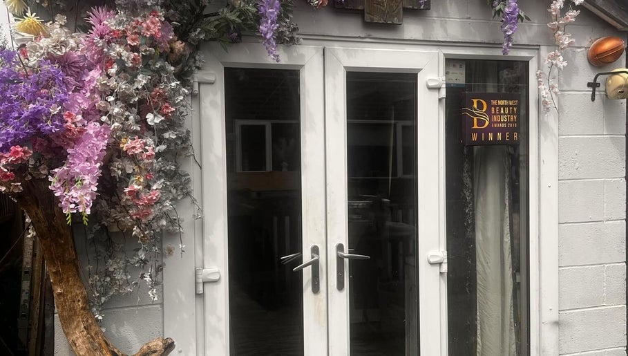 Floral-adorned entrance of Meraki Beauty and Aesthetics, Penwortham, England. Award-winning beauty venue.