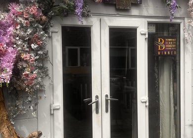 Floral-adorned entrance of Meraki Beauty and Aesthetics, Penwortham, England. Award-winning beauty venue.