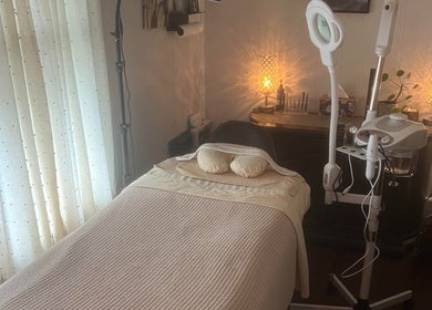 A cozy treatment room at LSL Lash Studio Red Bank, Red Bank, New Jersey, US with a massage table and soft lighting.
