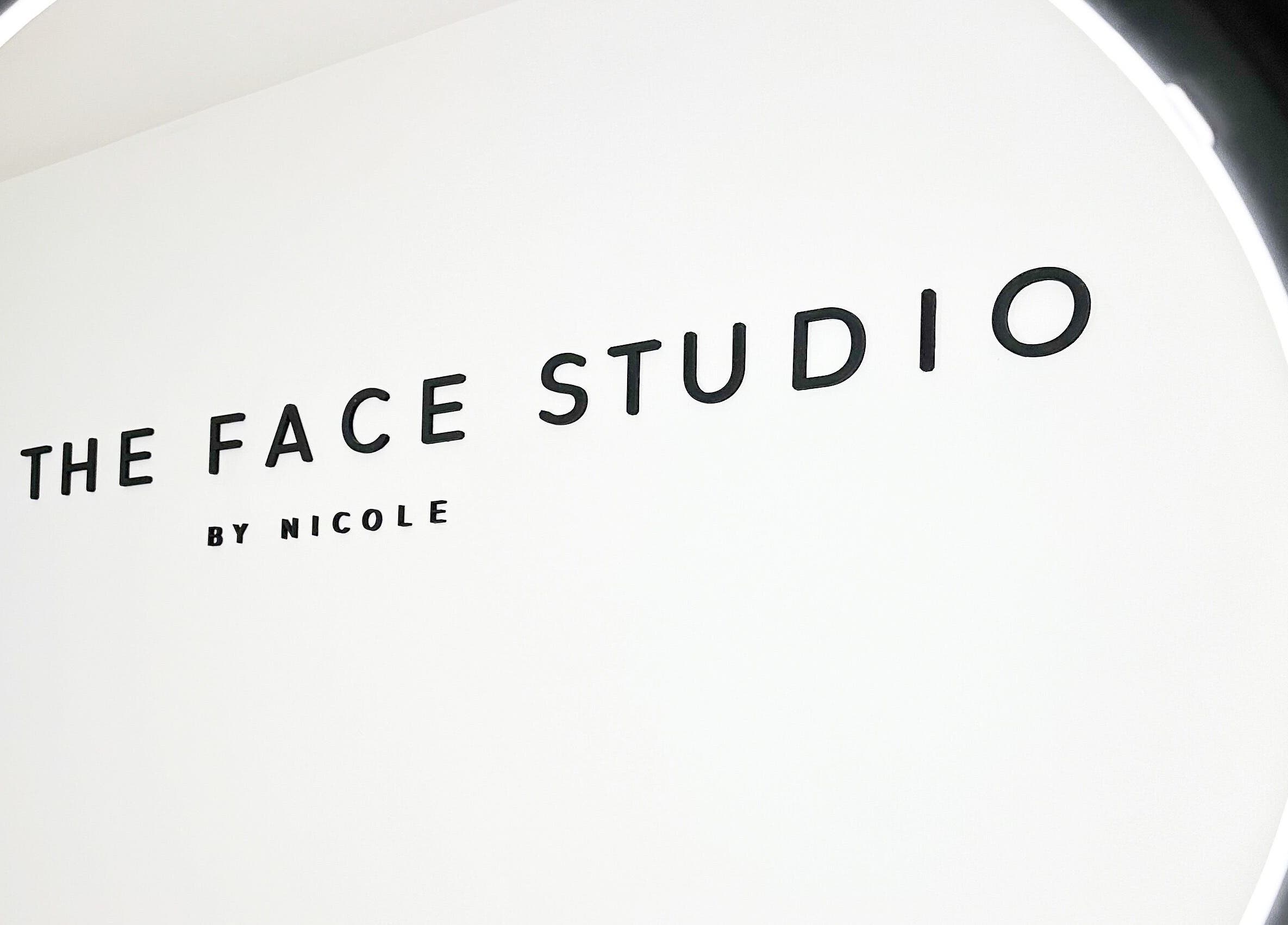 The Face Studio sign in Aston-on-trent, England, GB under a circular light.
