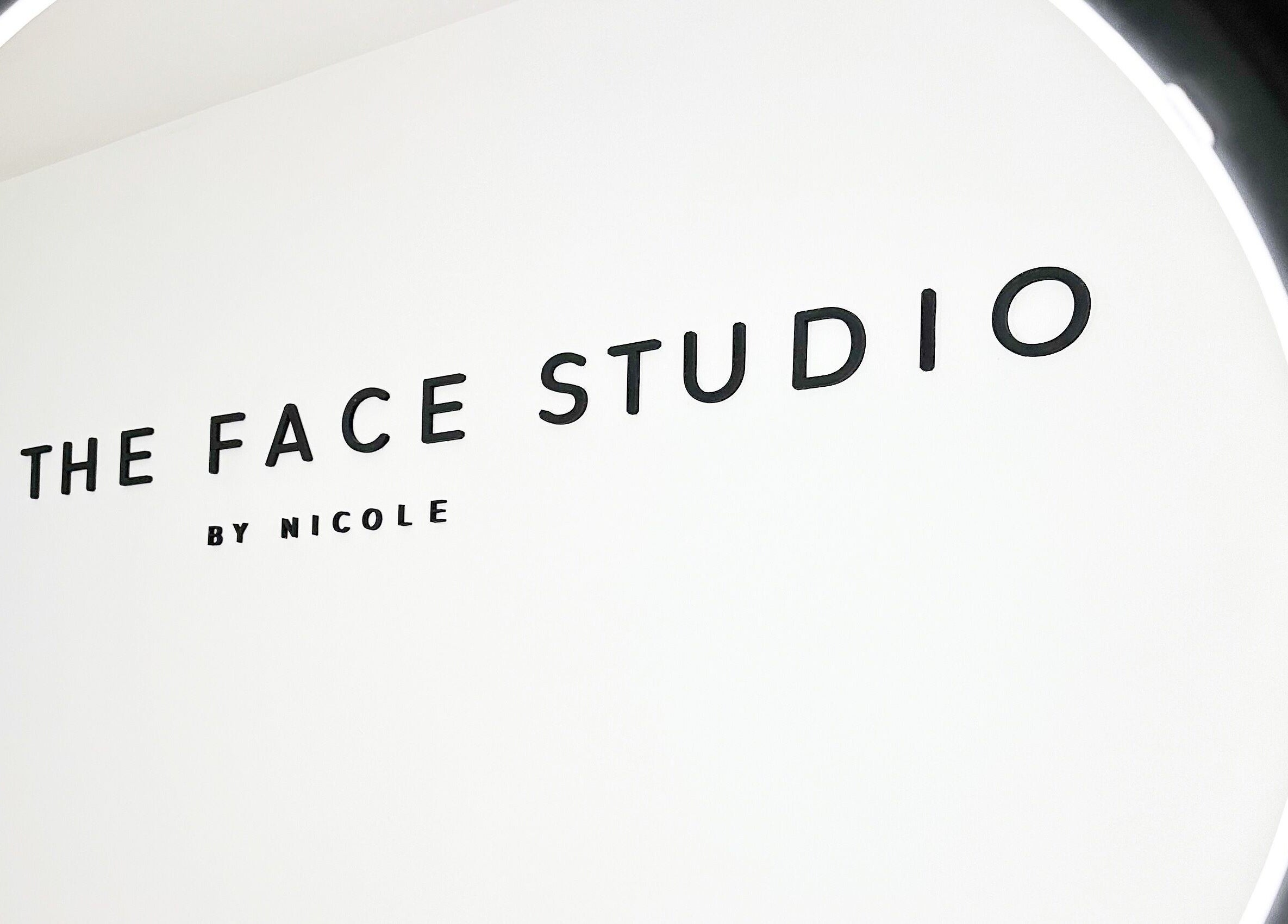 The Face Studio sign in Aston-on-trent, England, GB under a circular light.