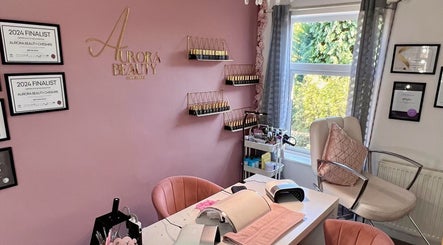 Elegant Aurora Beauty Cheshire salon in Congleton, England with awards, equipment, and pink decor.