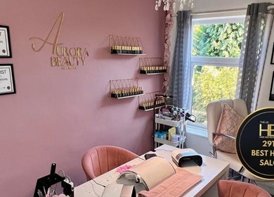 Elegant interior of Aurora Beauty Cheshire salon in Congleton, England, showcasing awards and modern decor.